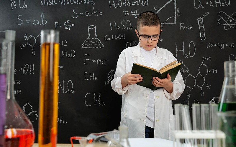 periodic table and a highlighted textbook open beside them